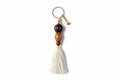 Keychain with beads and tassel on a neutral background