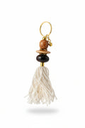 Keychain with beads and a tassel on a neutral background