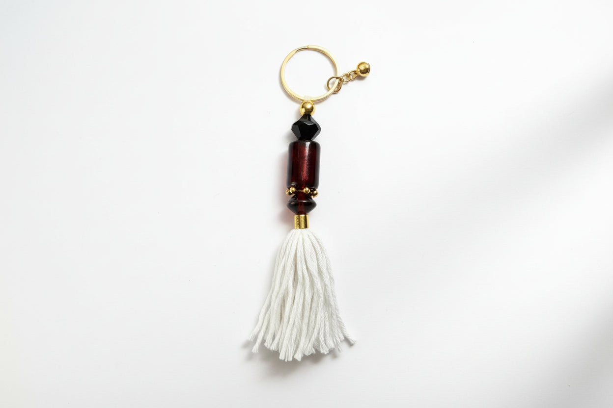 Keychain with beads and tassel on a gray background