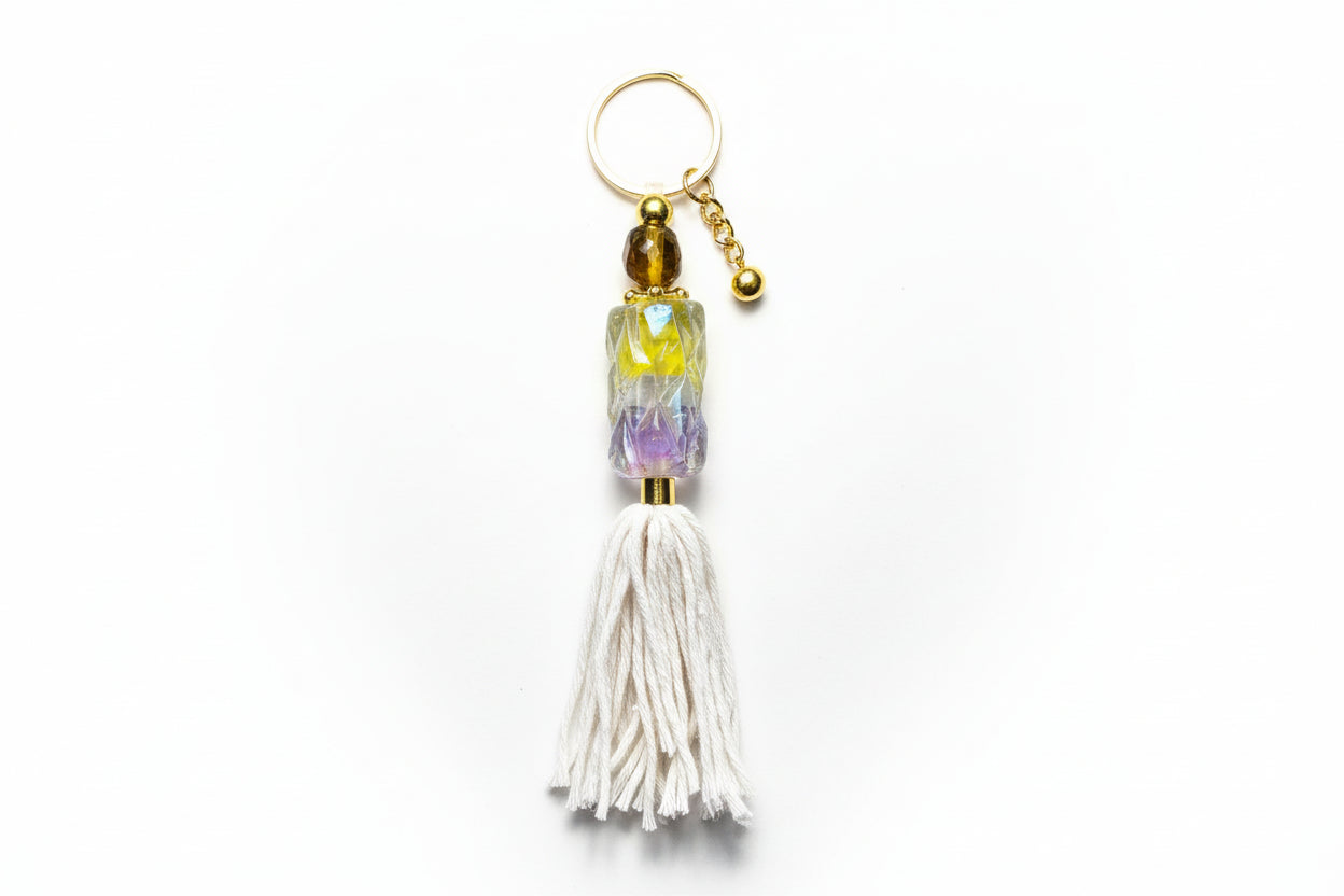Keychain with tassel and beads on a plain background