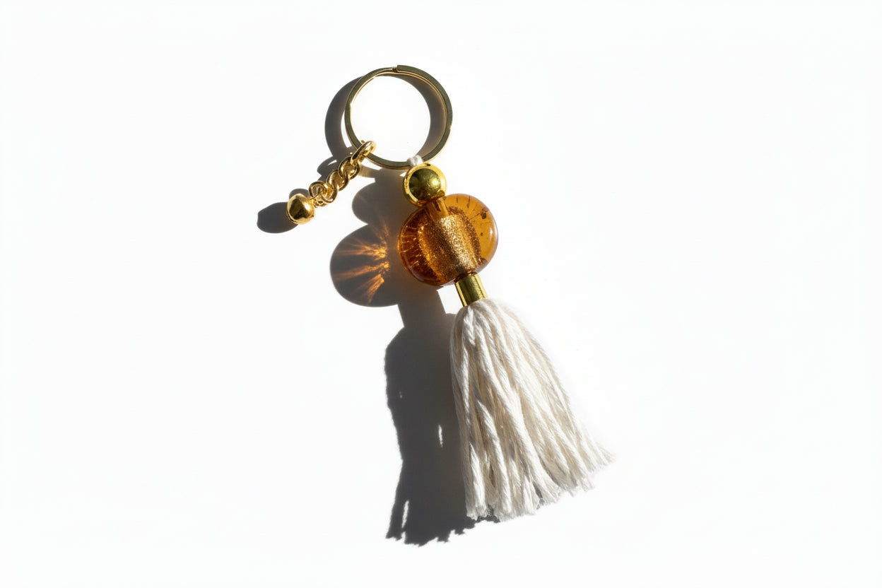 Keychain with a tassel and decorative bead on a gray background