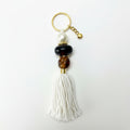 Keychain with beads and tassel on a gray background