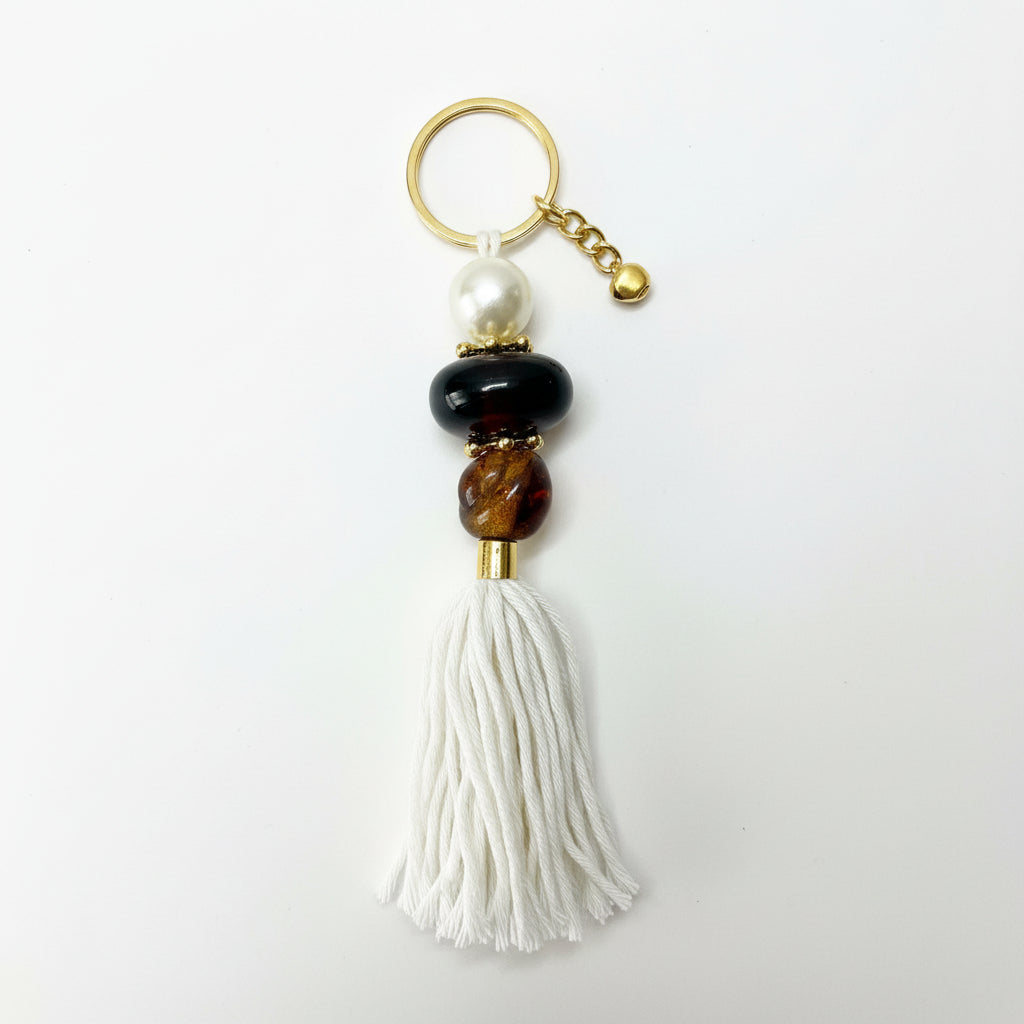 Keychain with beads and tassel on a gray background
