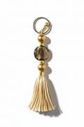 Keychain with beads and tassel on a neutral background