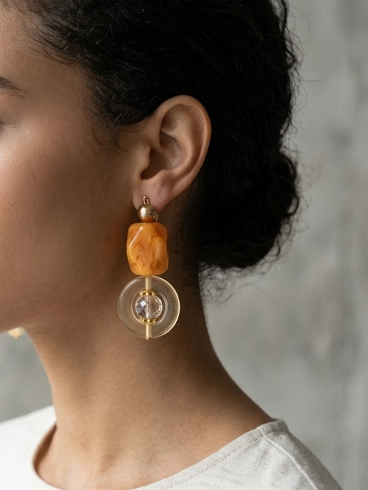 Woman wearing earrings with a neutral background